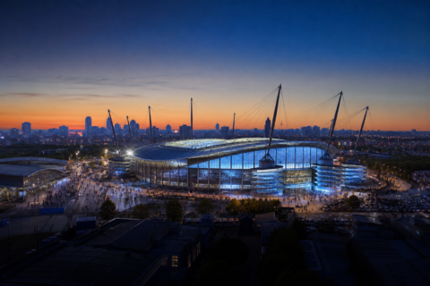 Etihad Stadium exterior glowing before a Manchester City home match