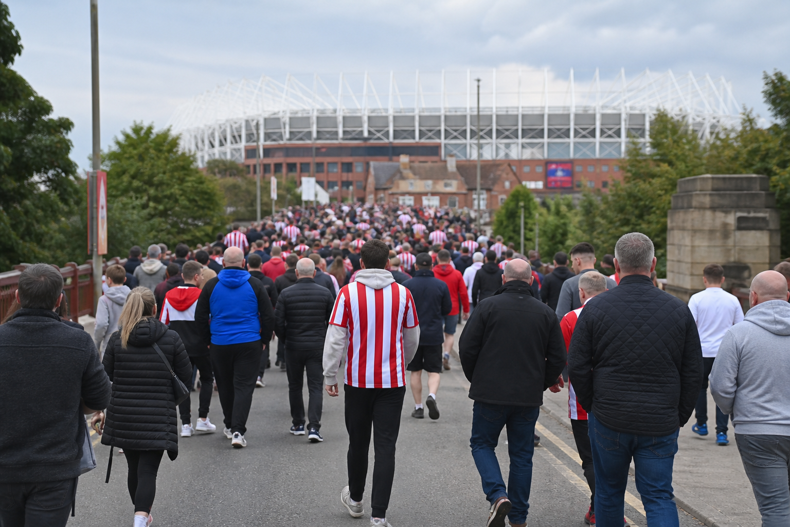 Travelling fans arriving at the Stadium of Light beside the Wear