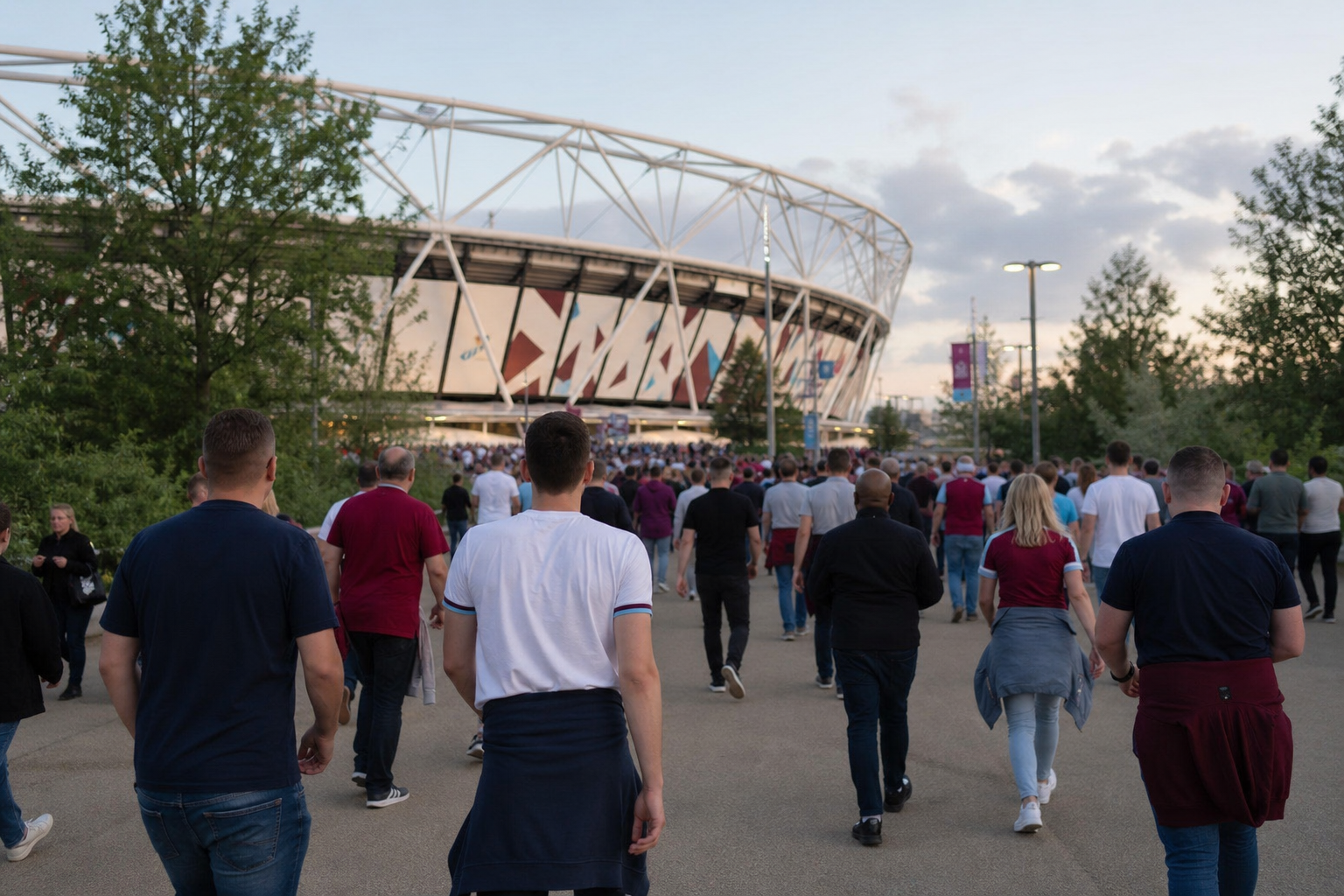 Supporters walking along the approach to Tottenham Hotspur Stadium before kick-off