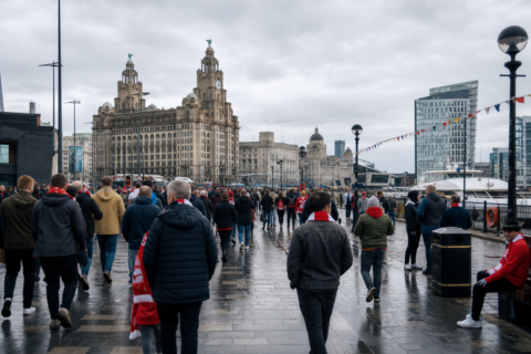 Liverpool waterfront skyline with football fans crossing toward a derby match