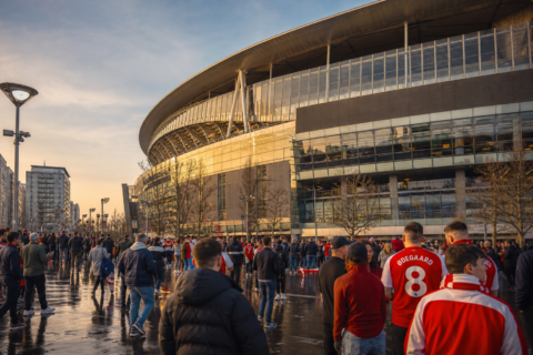 Exterior view of Emirates Stadium with fans in red and white gathering before kick-off