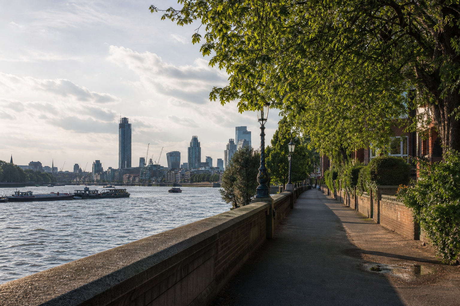Thames riverside walk near Fulham with the city skyline in soft afternoon light