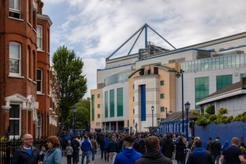 Stamford Bridge stadium entrance with Chelsea fans gathering on Fulham Road