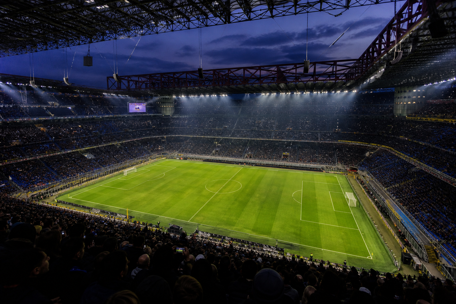 Inside a large Italian stadium bowl with blue-and-black supporters before kick-off